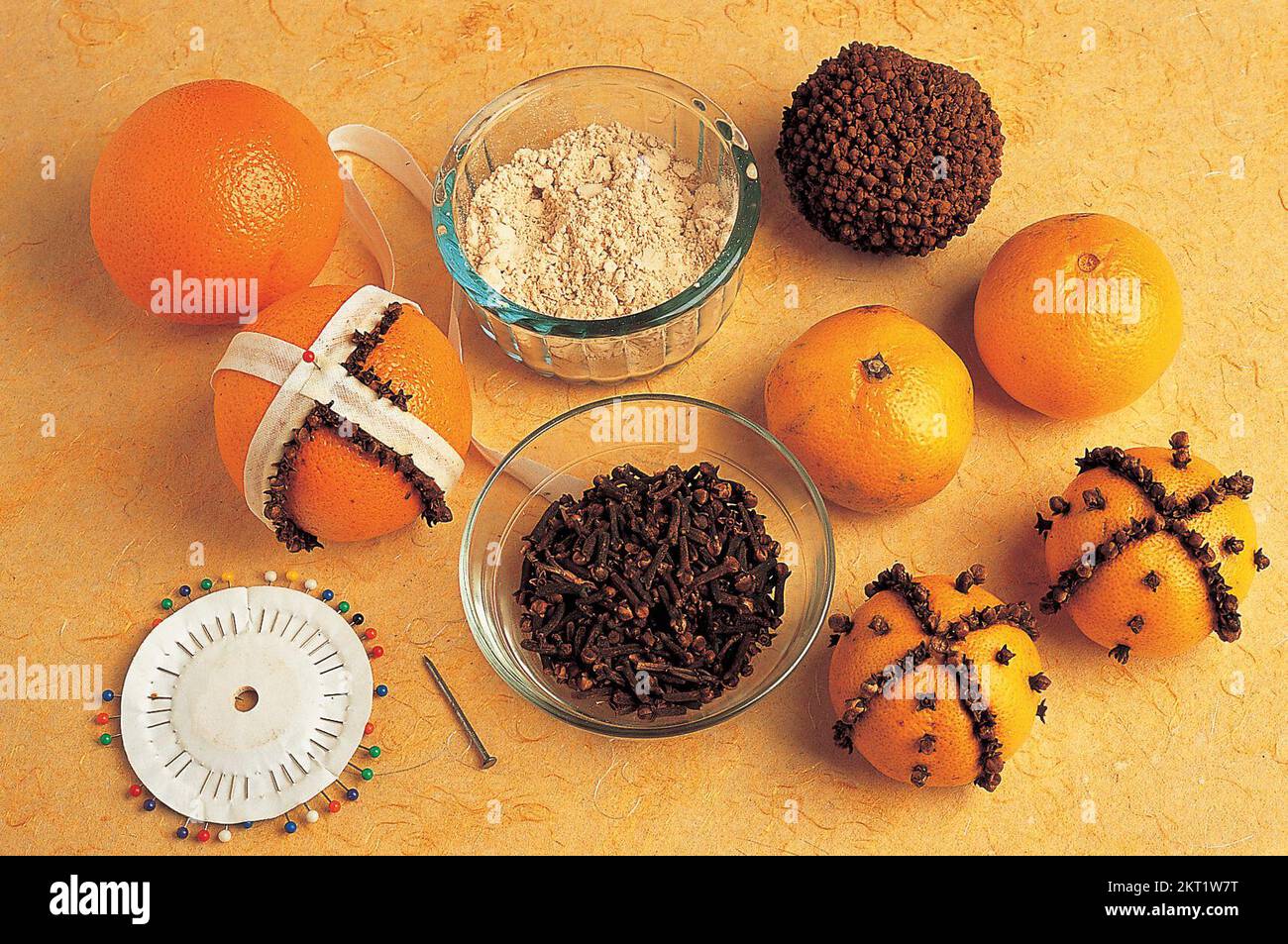 Decorating the oranges with whole cloves Stock Photo Alamy