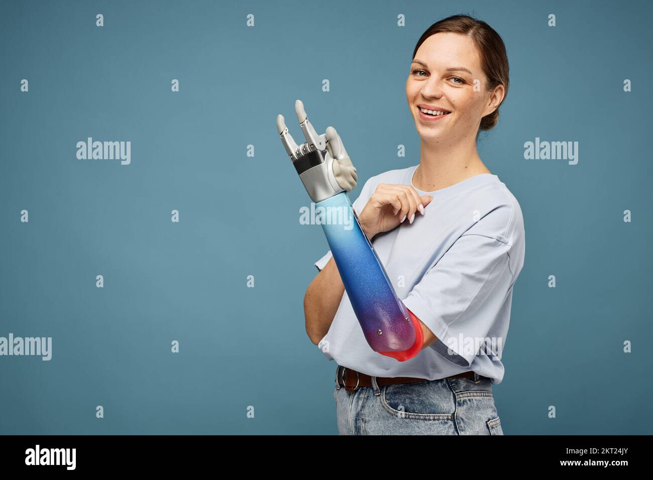 Portrait of positive young woman making rock hand sign Stock Photo - Alamy