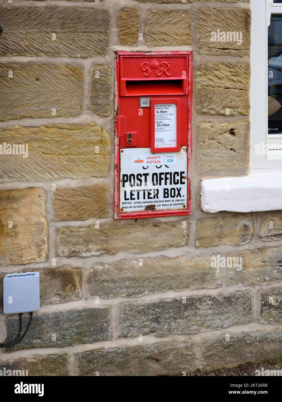 Priority GR Post Office letter box let into the wall of a stone