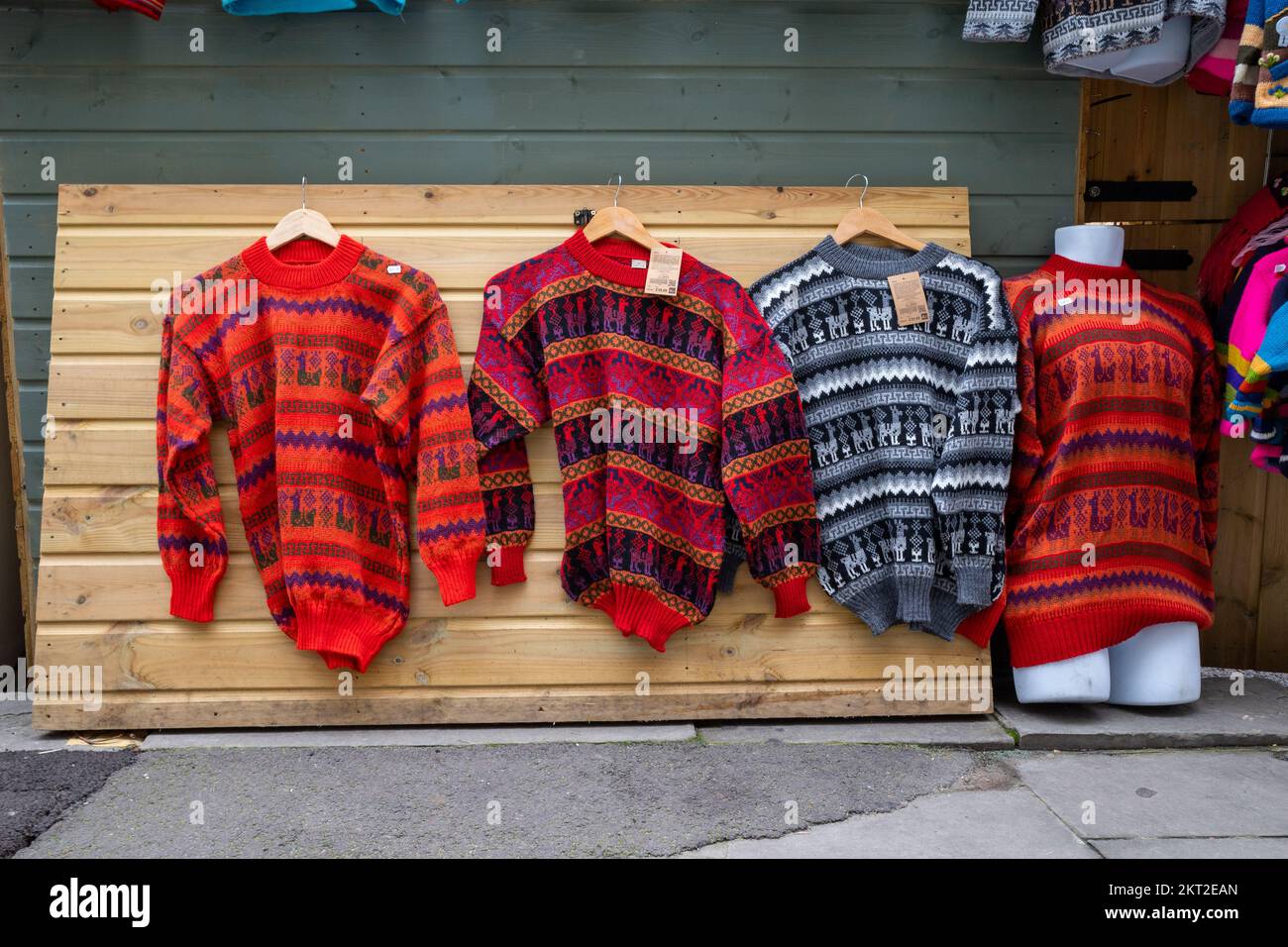 Handmade woollen knitted jumpers on a stall at Bath Markets (Nov22) Stock Photo