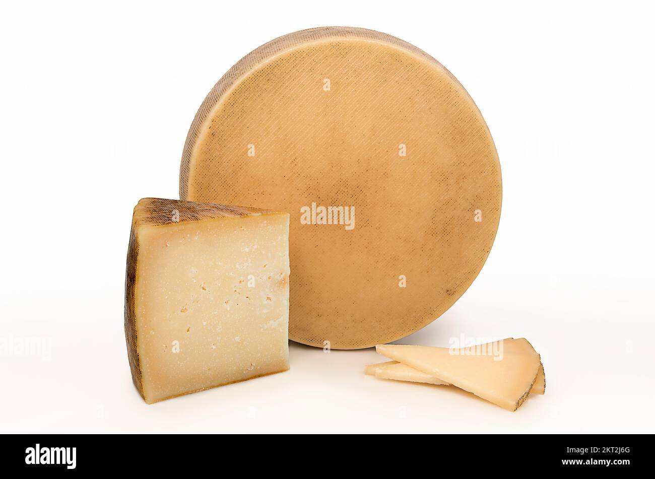 Whole cheese next to a wedge and some textured portions on their rinds ...