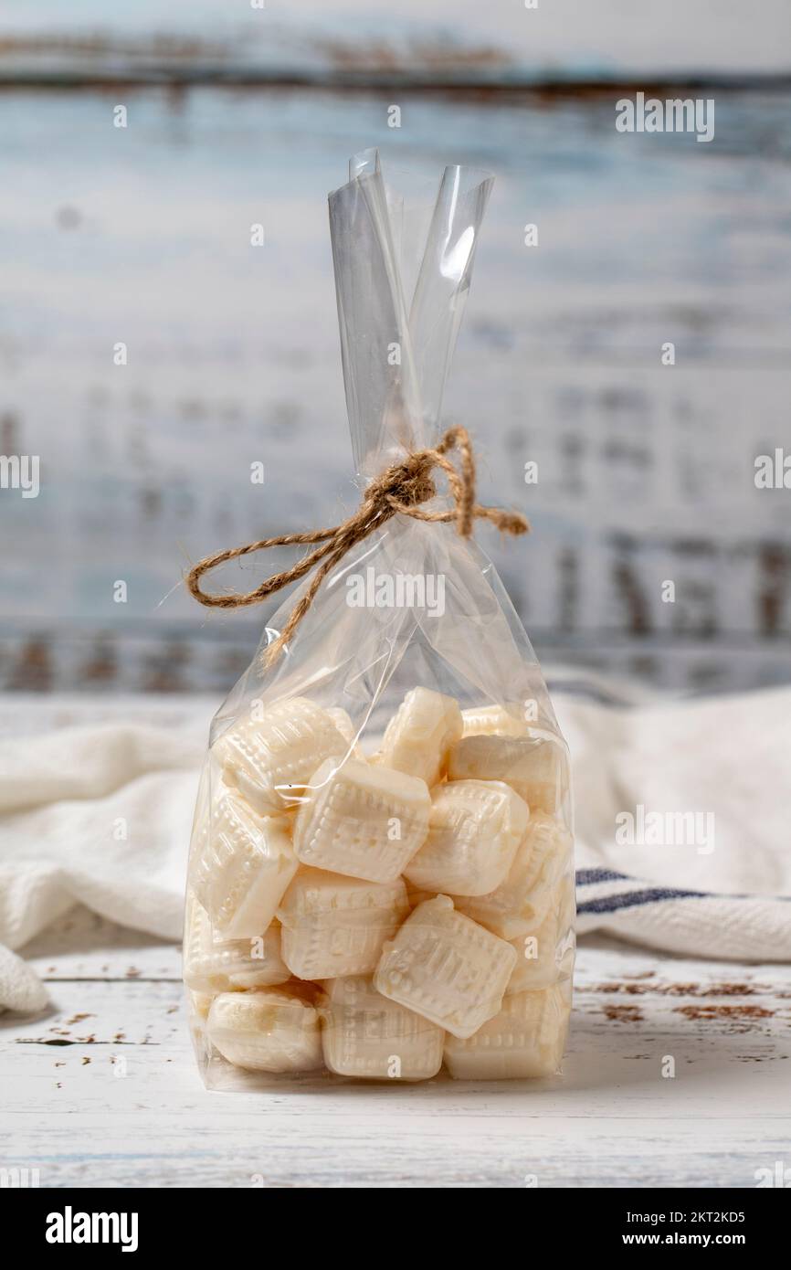 Milk candy. Candy on a white wood background. close up Stock Photo