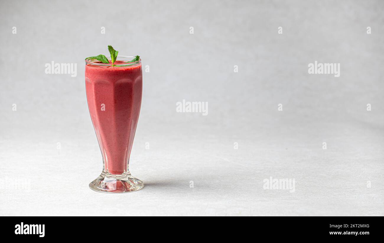 Glass of fresh berry smoothie with mint Stock Photo