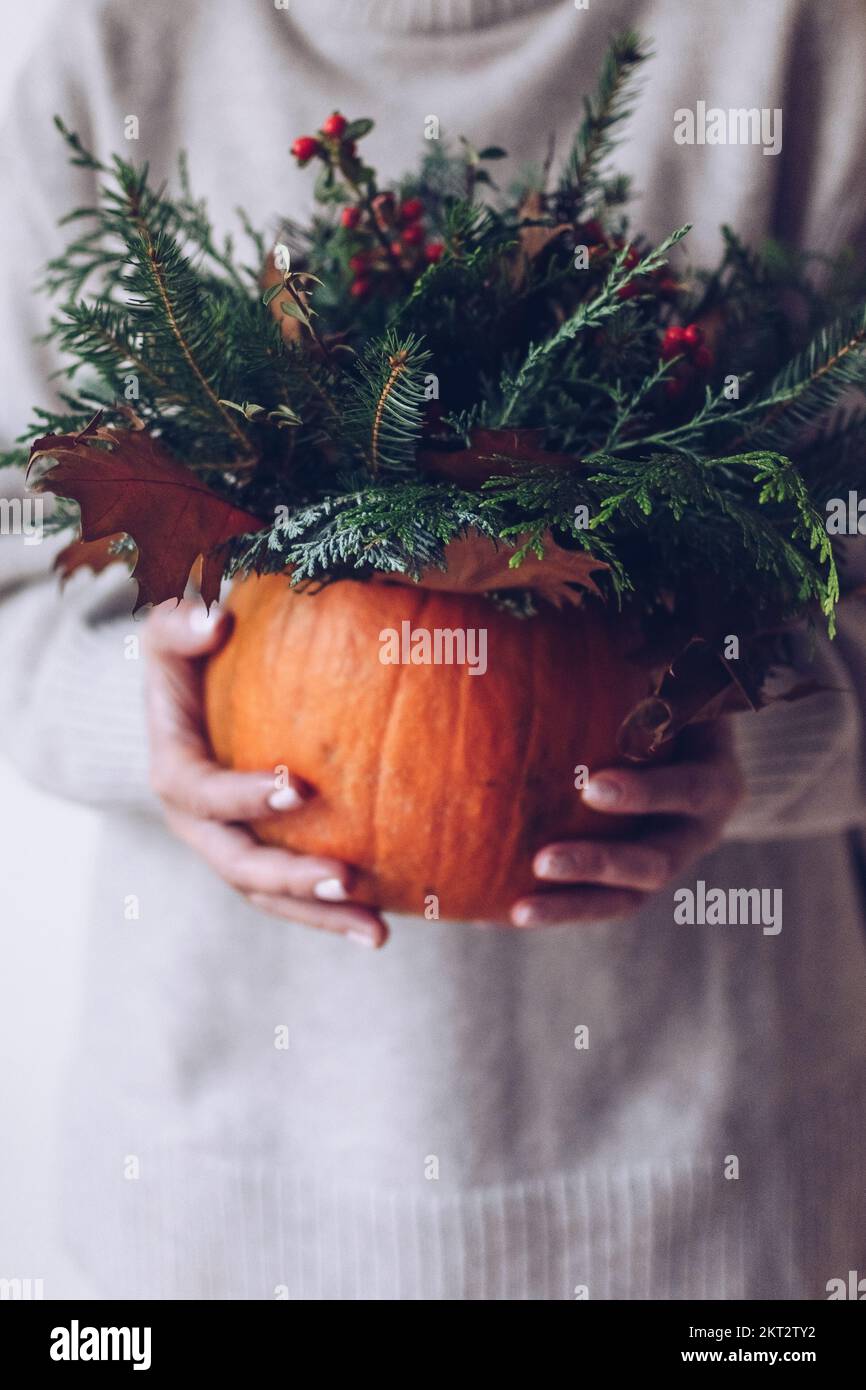 Rich autumn bouquet with a pumpkin in the hands of a girl on a light background Stock Photo