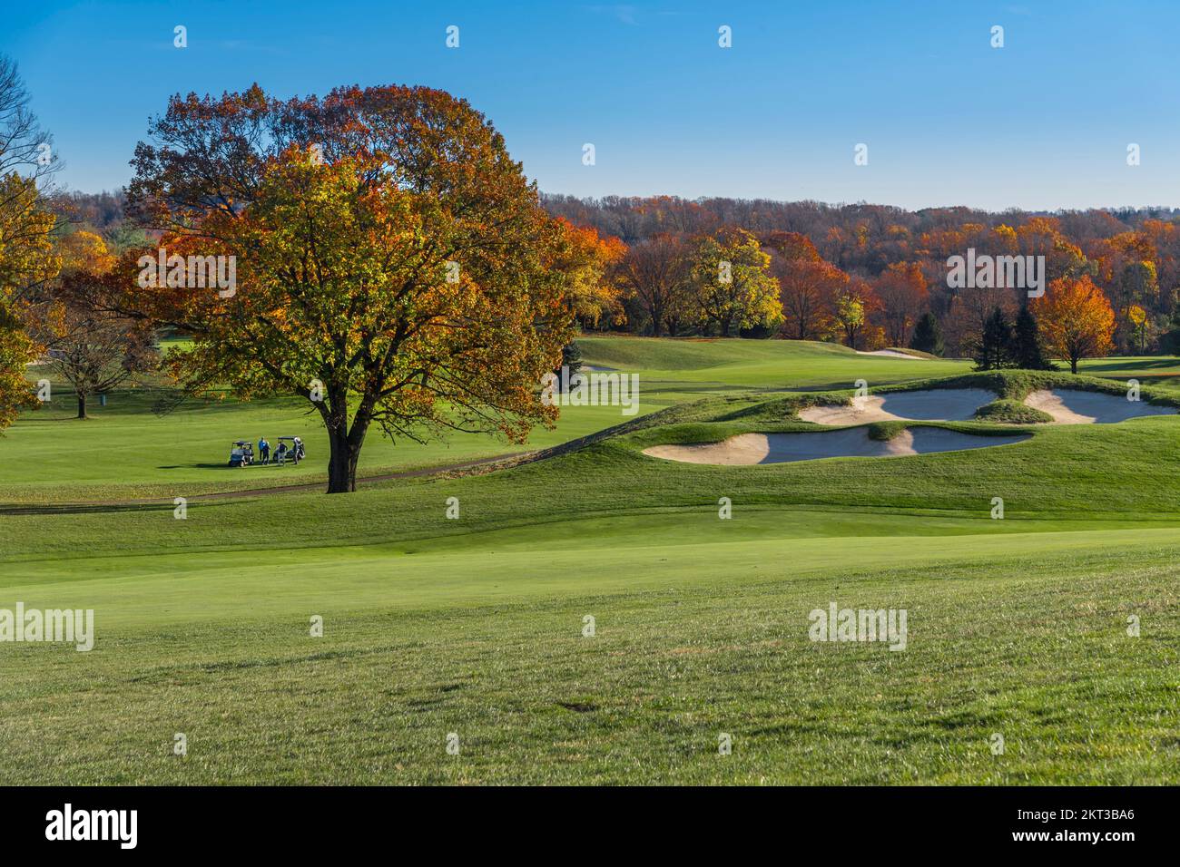 Beautiful fall autumn day at golf course with distant foursome golfing, Pennsylvania, USA Stock Photo