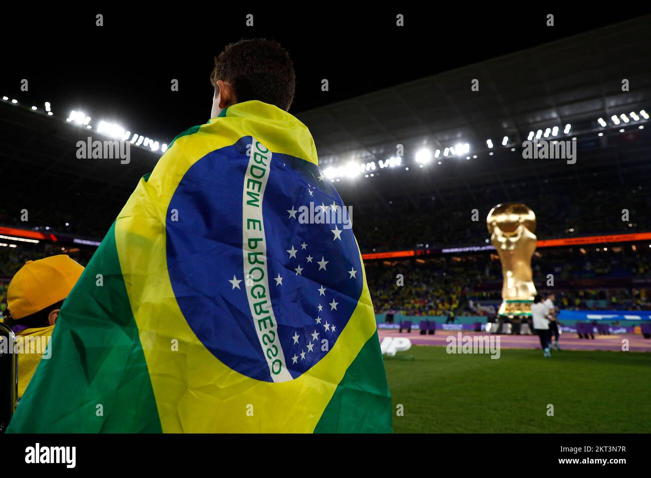 28th November 2022; Stadium 974, Doha, Qatar; FIFA World Cup Football, Brazil versus Switzerland; Brazil mascot wearing the Brazil flag as a cape watches the Brazil team walk onto the pitch Stock Photo