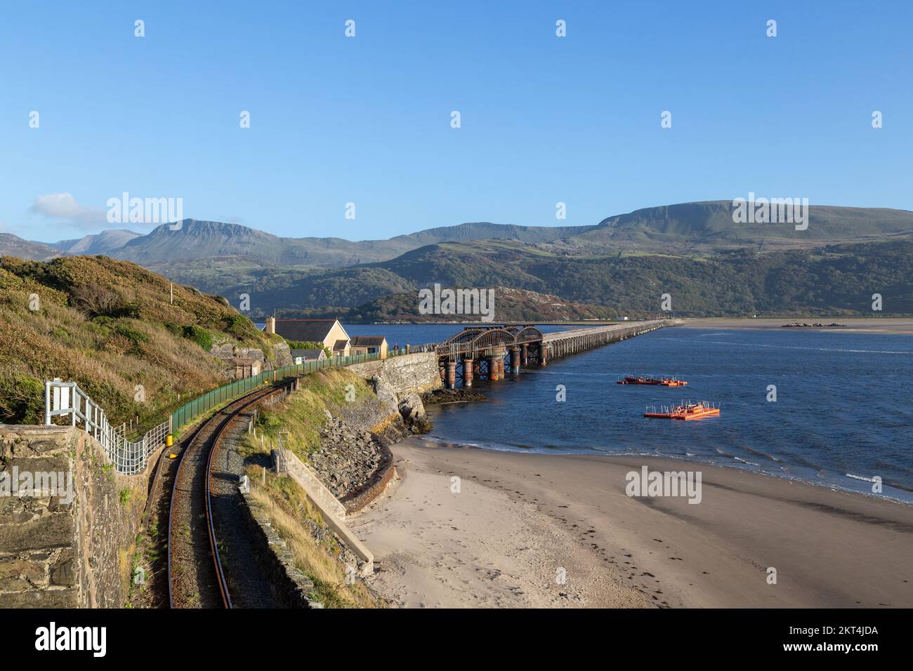 Looking towards Cadair Idris or Cader Idris with the Barmouth railway bridge in the foreground. Stock Photo