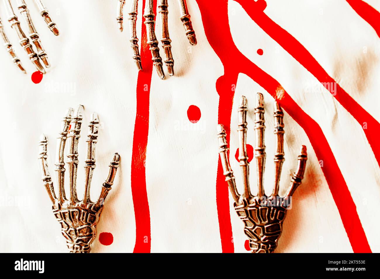 Futuristic horror scene on skeletal tech hands over blood splattered background. Deadly design Stock Photo
