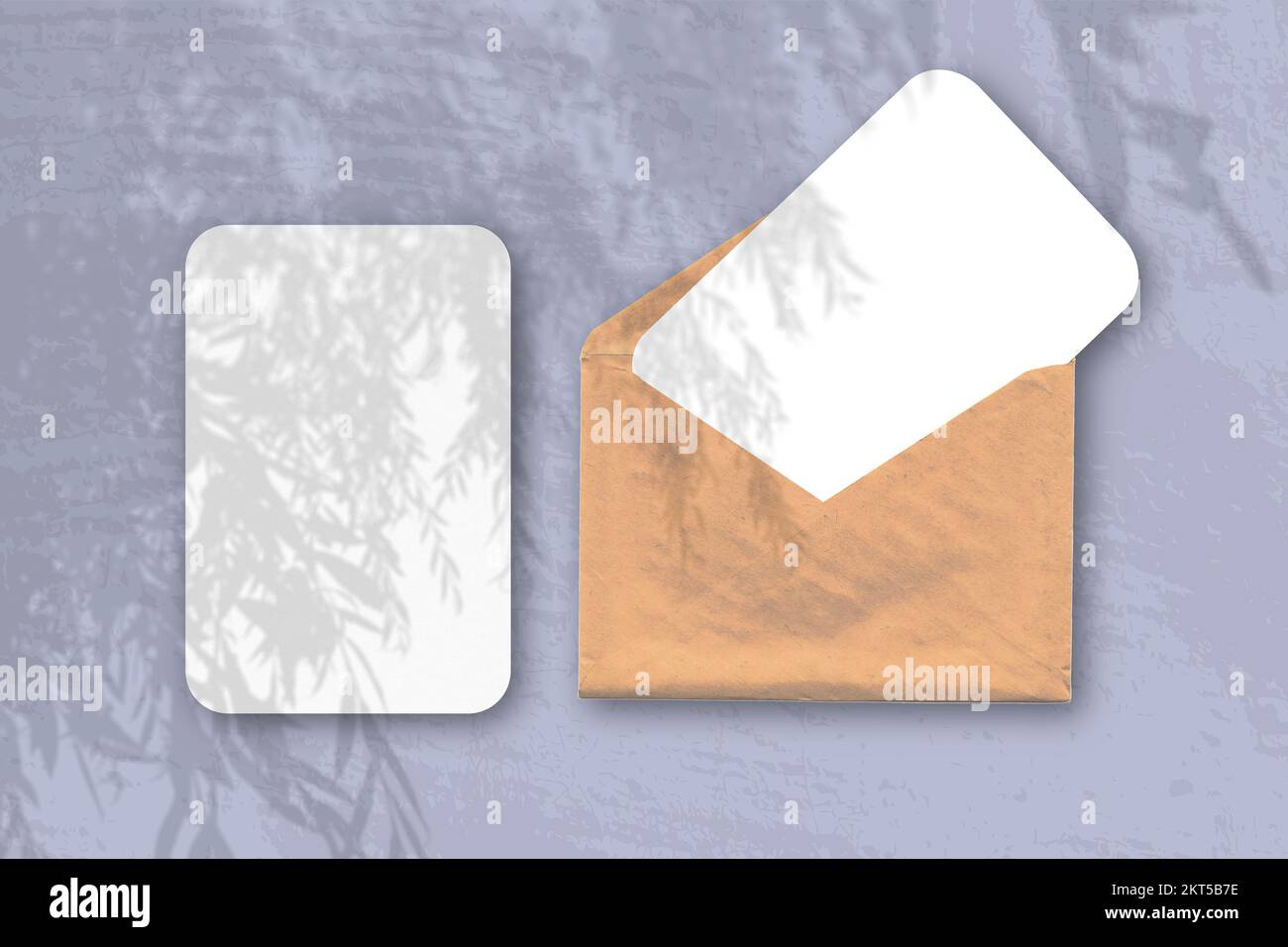 An envelope with two sheets of textured white paper on the blue