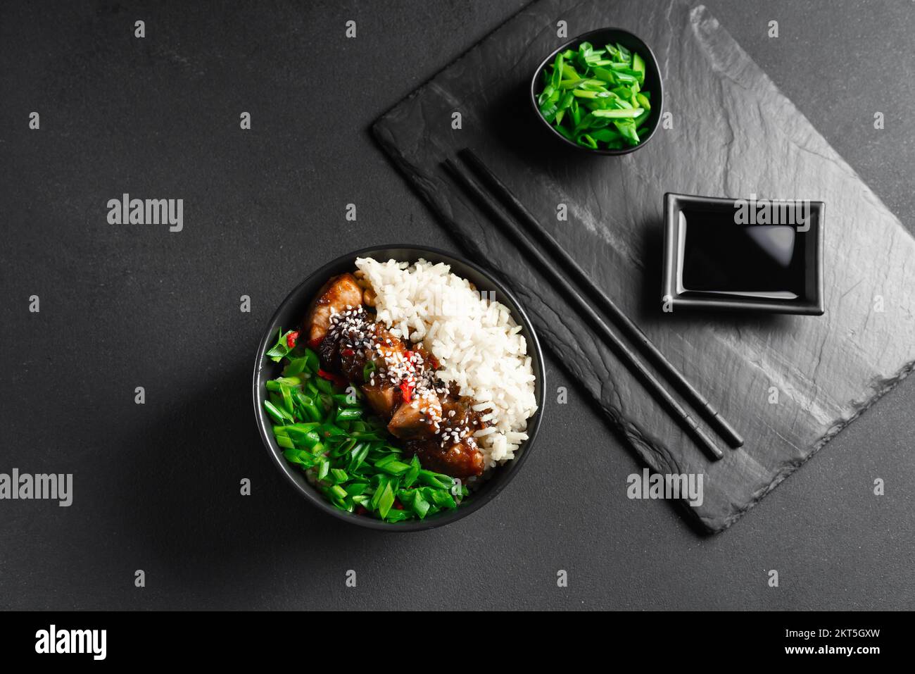 Asian food. Asianstyle kung pao chicken with rice and green onions