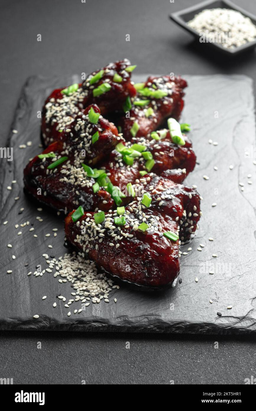 Chicken wings. Traditional asian recipe. Dark background. Top view. Chicken wings in teriyaki sauce. Asian chicken wings on a dark background. Chicken Stock Photo