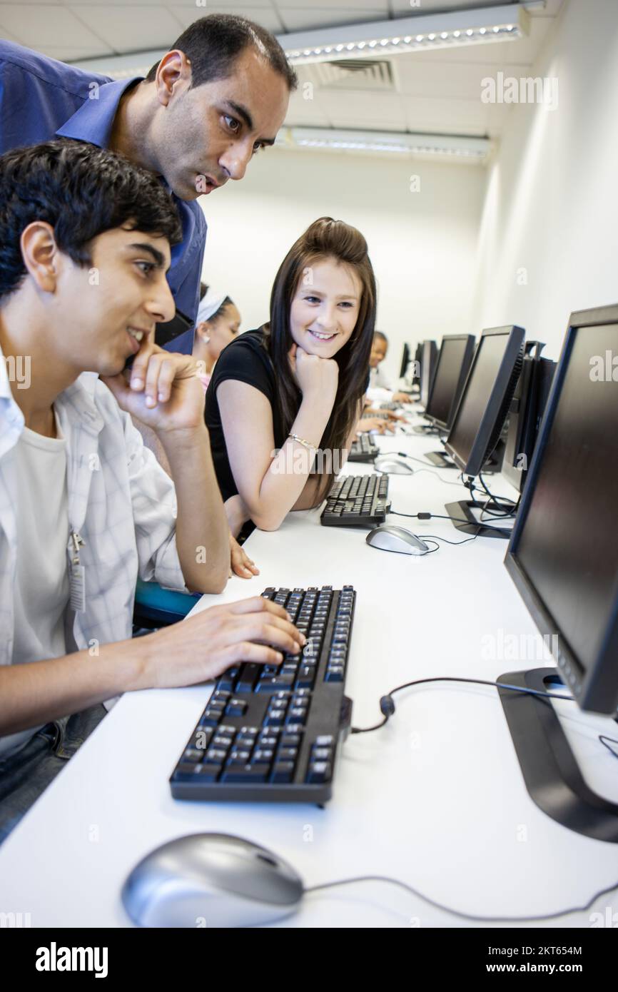 Indian teacher with students at computer hi-res stock photography and ...
