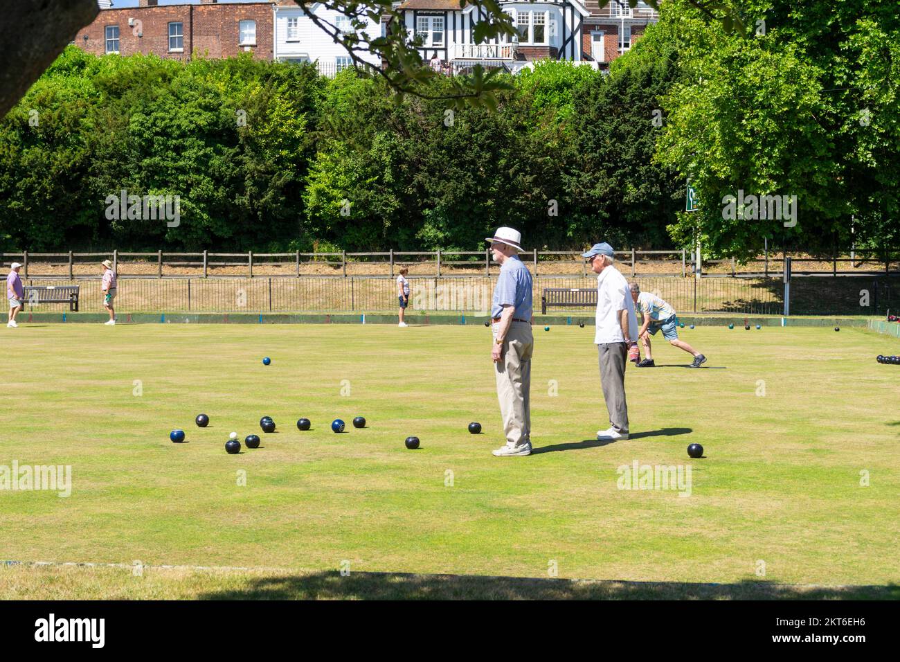 Men playing a game of bowls on a bowling green Rye East Sussex England