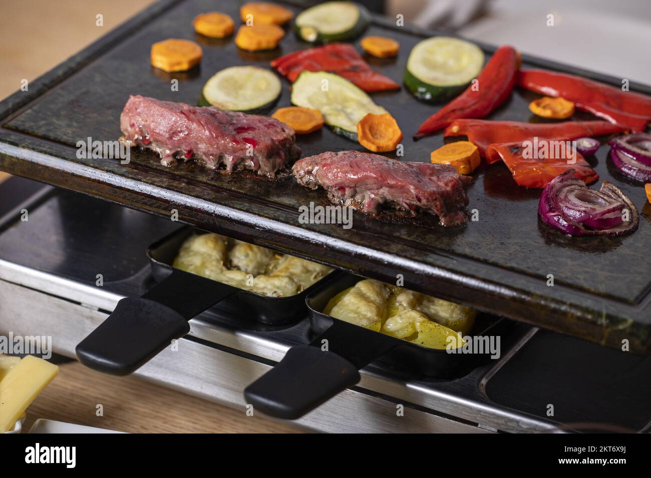 Swiss Raclette With Meat And Vegetables Stock Photo - Alamy