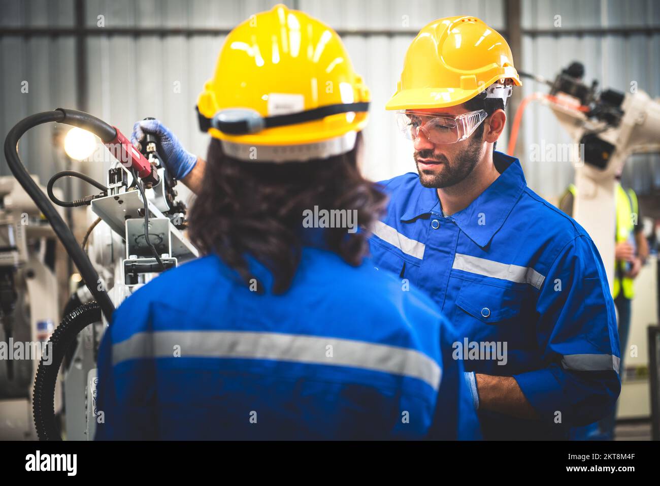 Two engineers mechanic using computer controller Robotic arm for ...