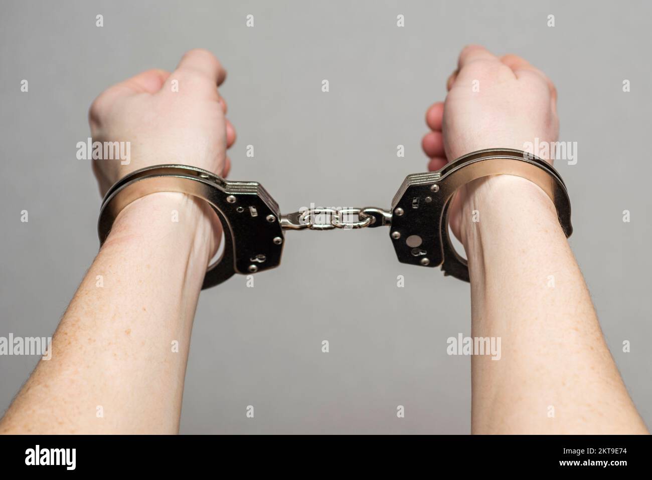 Hands in handcuffs. Prisoner or arrested man ,closeup of hands in