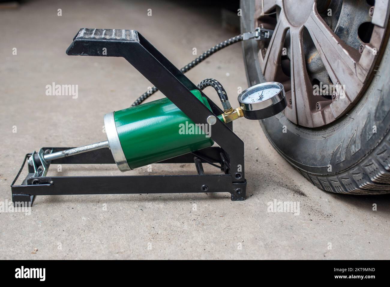 Foot pump near the car with flat tire on the road Stock Photo Alamy