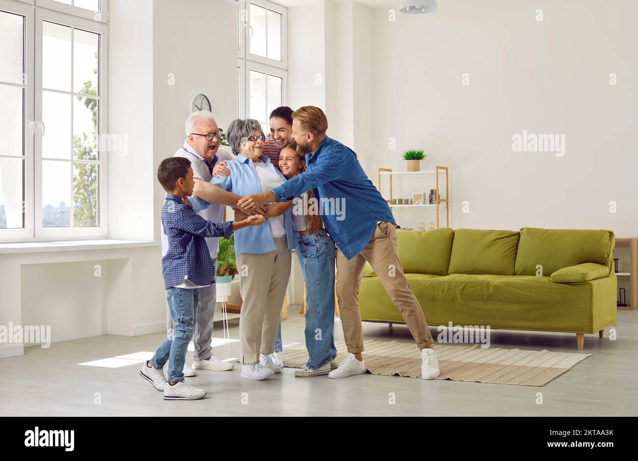 Happy big family hugs their beloved grandmother . Stock Photo
