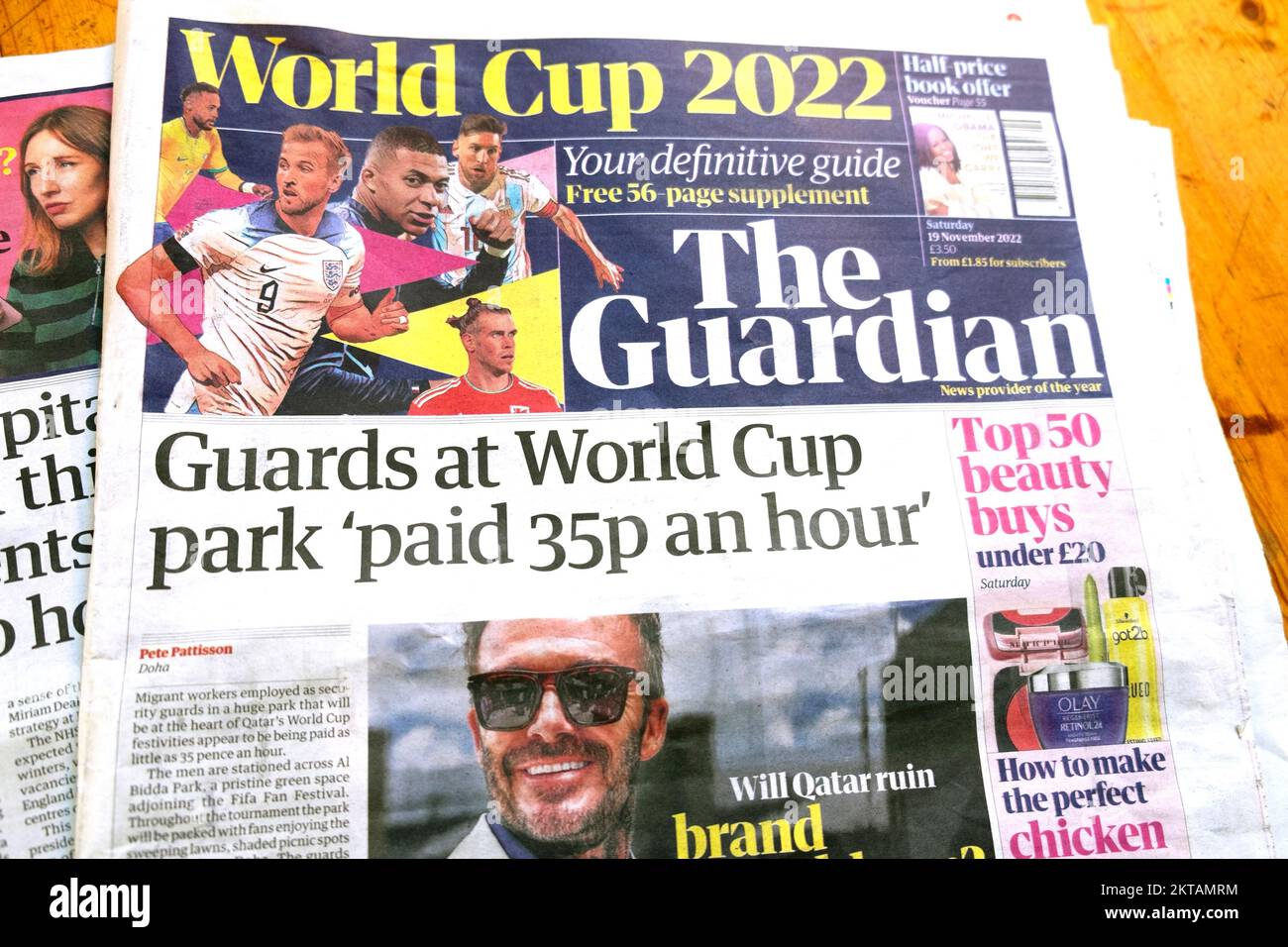 'Guards at World Cup park 'paid 35p an hour' David Beckham front page Guardian newspaper headline Qatar World Cup 2022 football article London UK Stock Photo