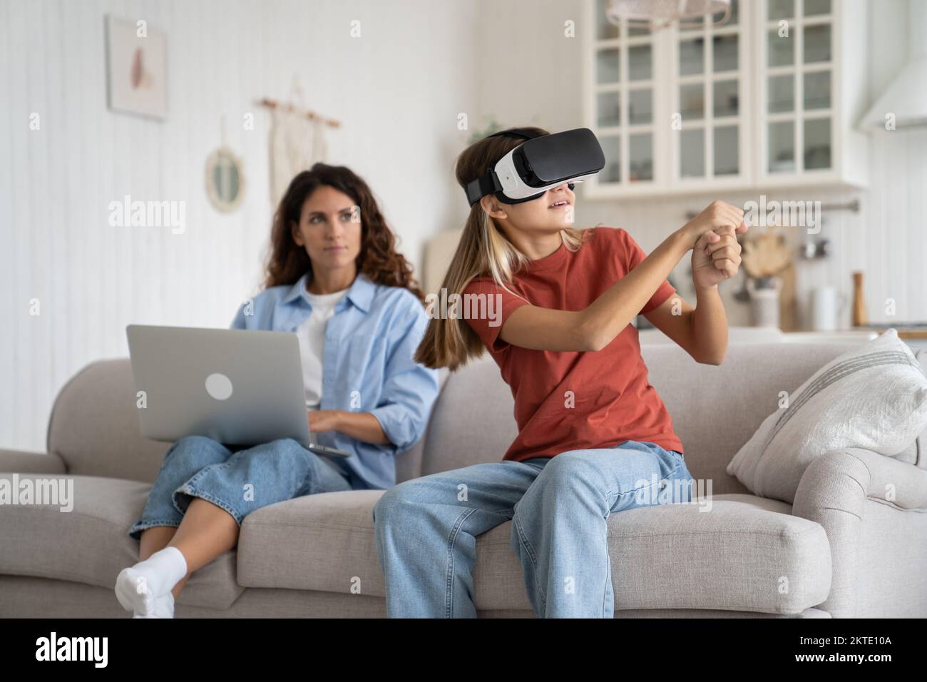 Enthusiastic positive teenage girl with vr glasses with virtual
