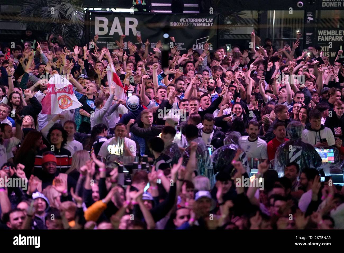 England fans at BoxPark Wembley celebrate their second goal scored by Phil Foden, during a screening of the FIFA World Cup Group B match between Wales and England. Picture date: Tuesday November 29, 2022. Stock Photo