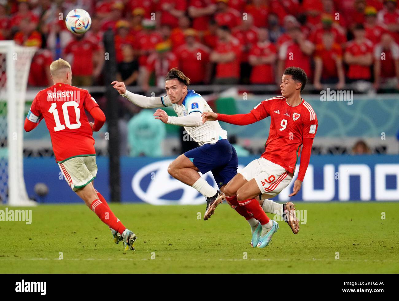 England's Jack Grealish battles with Wales' Brennan Johnson and Aaron Ramsey during the FIFA World Cup Group B match at the Ahmad Bin Ali Stadium, Al Rayyan, Qatar. Picture date: Tuesday November 29, 2022. Stock Photo