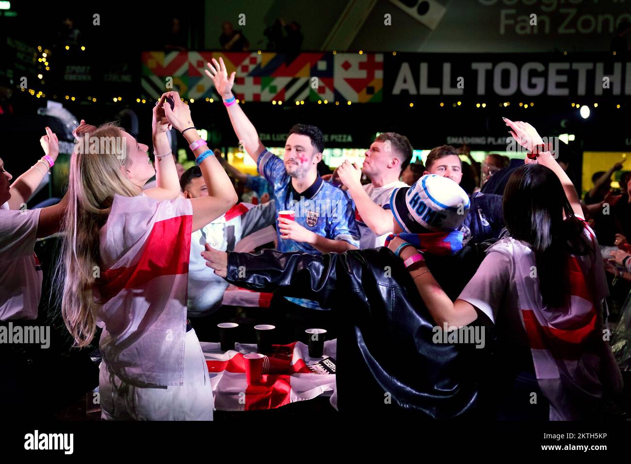 England fans celebrate after the final whistle at BoxPark Wembley, during a screening of the FIFA World Cup Group B match between Wales and England. Picture date: Tuesday November 29, 2022. Stock Photo