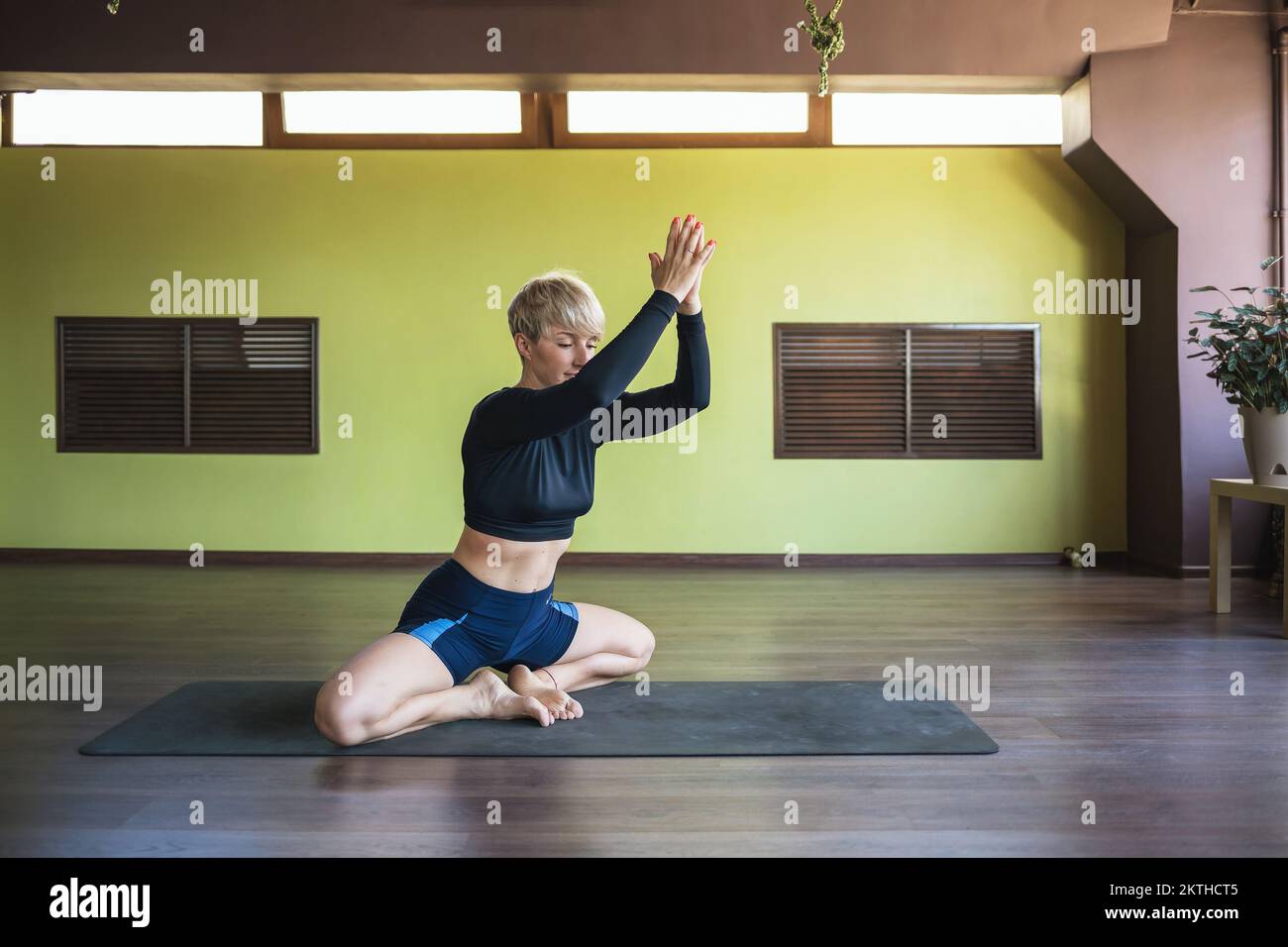 A woman leading a healthy lifestyle and practicing yoga, performs the