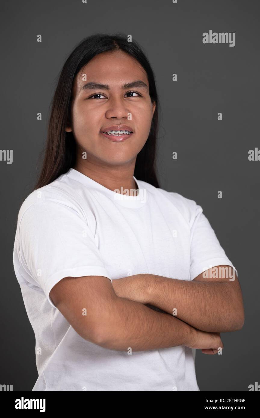 Smiling with teeth native american man with crossed arms isolated on studio background Stock Photo
