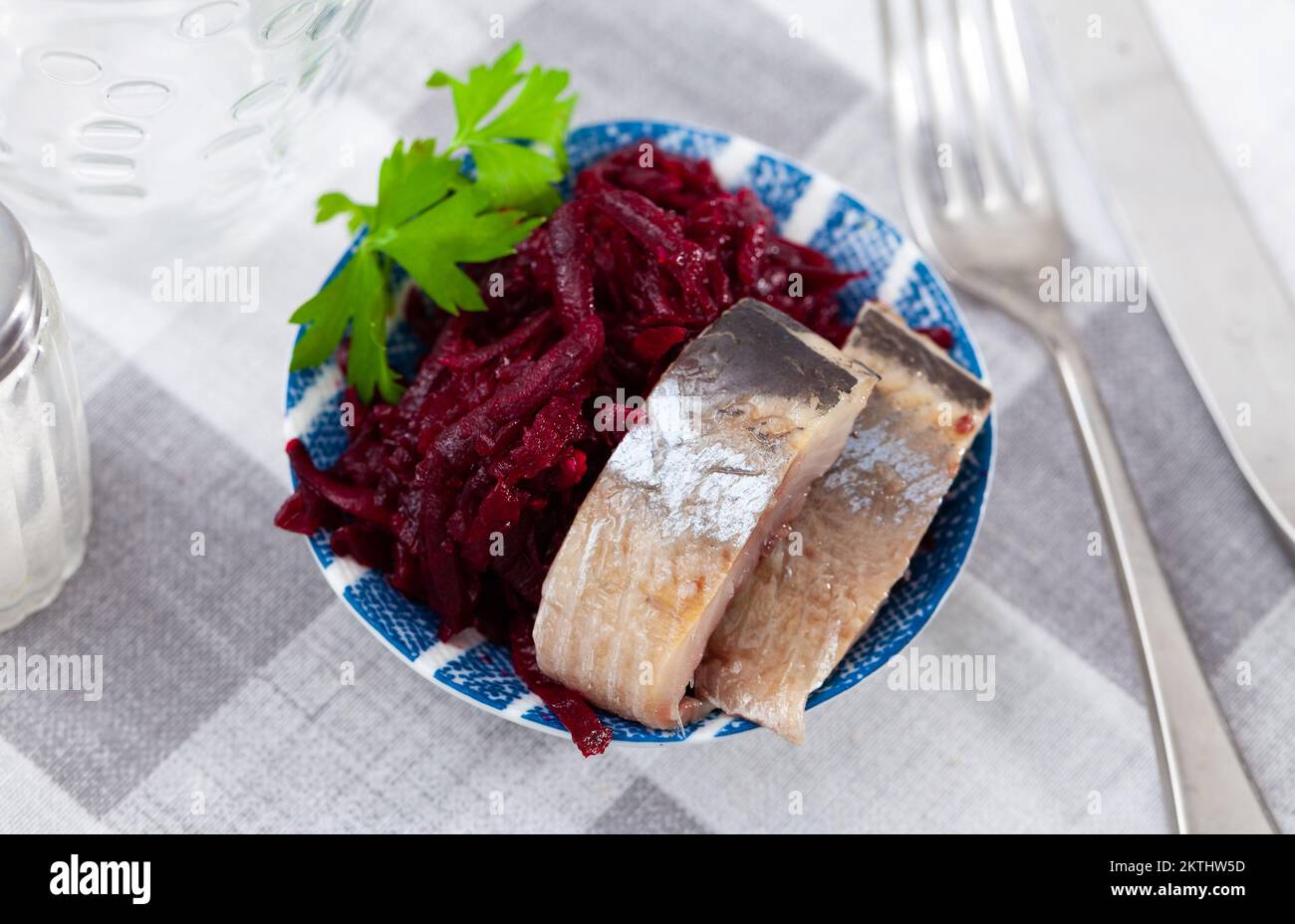 Sliced herring with grated beetroot served on table Stock Photo