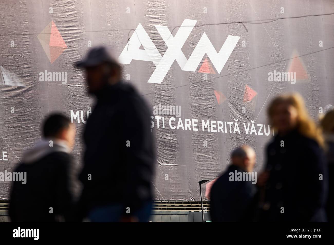 Bucharest, Romania - November 22, 2022: Extra large banner with AXN logo is displayed on the Unirea Shopping Center, in downtown Bucharest. This image Stock Photo