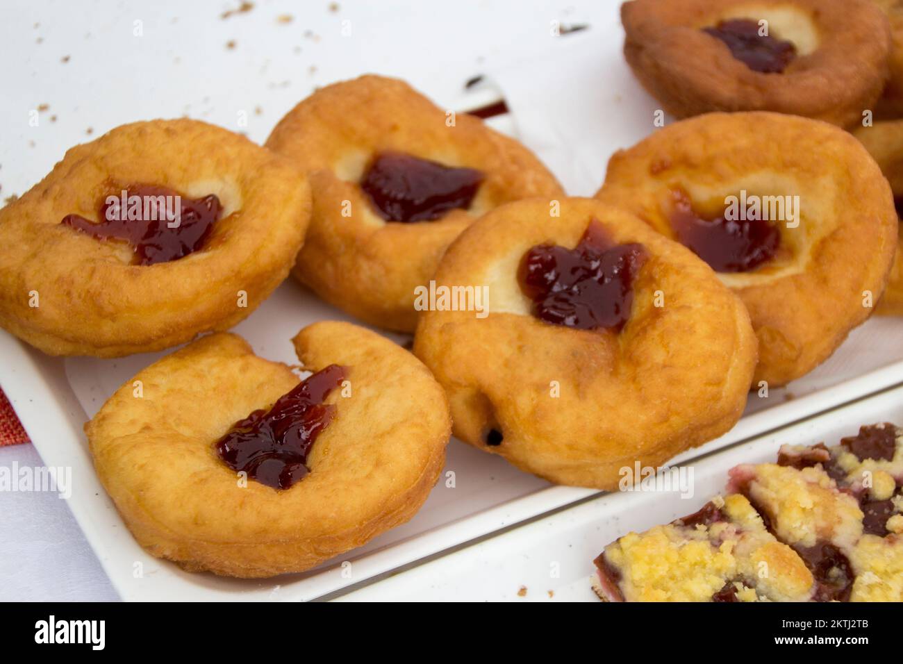 Deep-fried doughnut (paczki or sisky) topped with jam Stock Photo