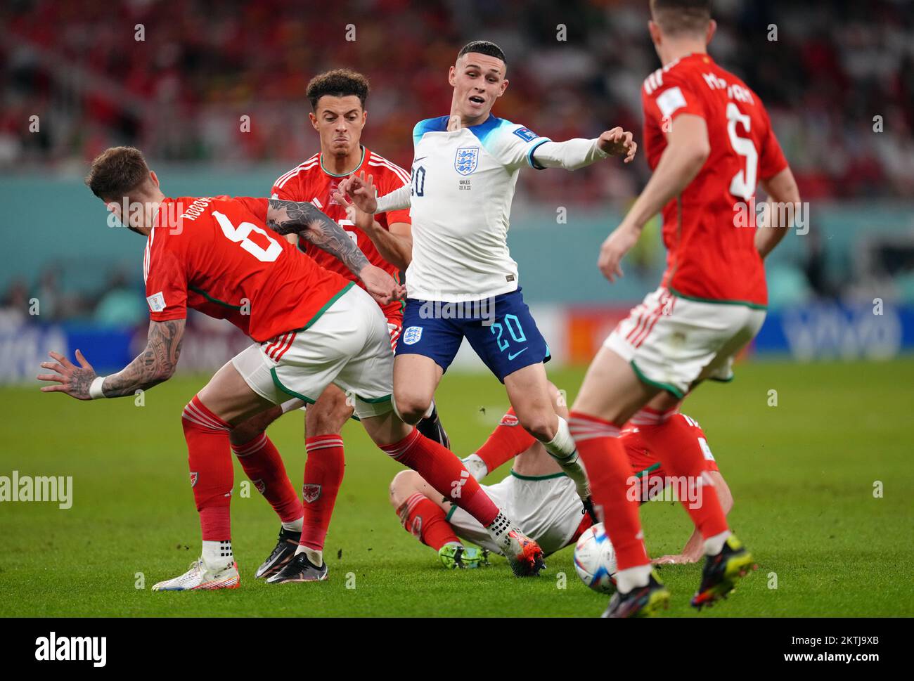 England's Phil Foden (centre) is fouled resulting in a free kick, which led to the opening England goal scored by Marcus Rashford during the FIFA World Cup Group B match at the Ahmad Bin Ali Stadium, Al Rayyan, Qatar. Picture date: Tuesday November 29, 2022. Stock Photo