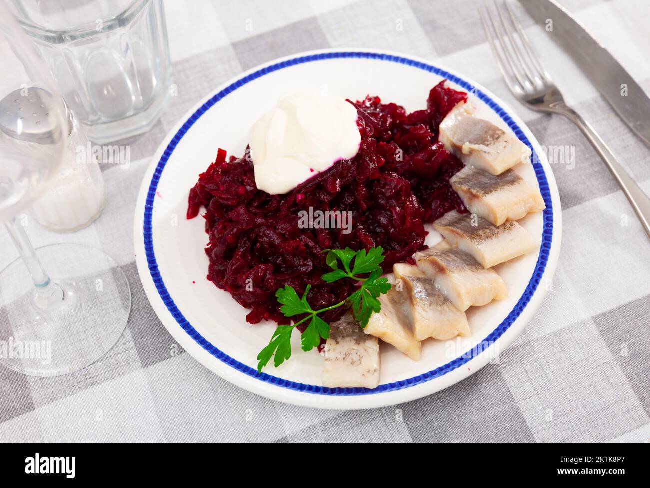 Sliced herring with grated beetroot served on table Stock Photo