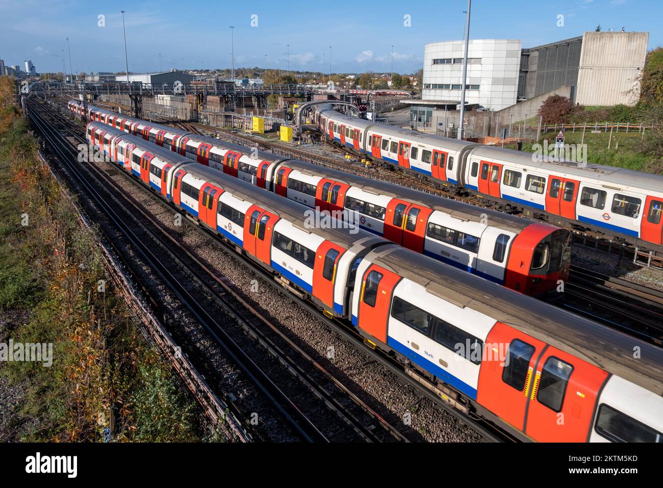 Three London tube trains pass each other at Neasden London Underground Train Depot - Jubilee Line, North West London, England, UK. Stock Photo
