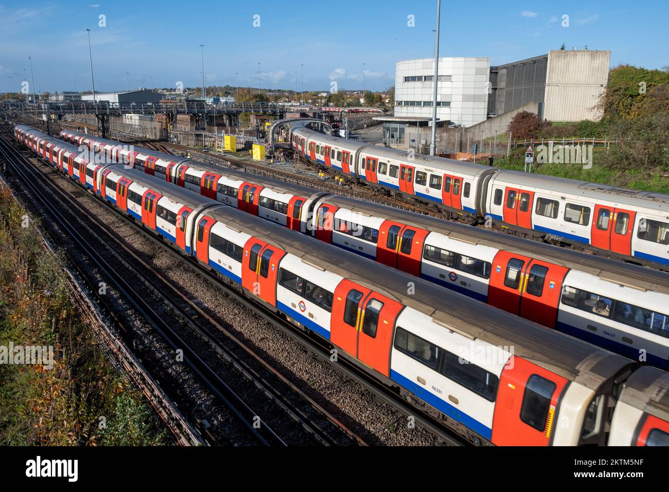 Three London tube trains pass each other at Neasden London Underground