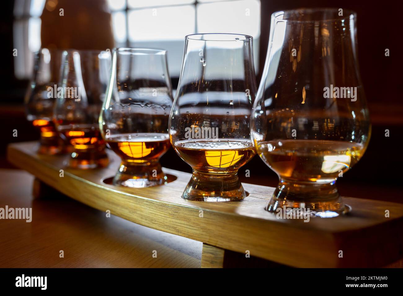 Flight of single malt scotch whisky in glasses served in bar in