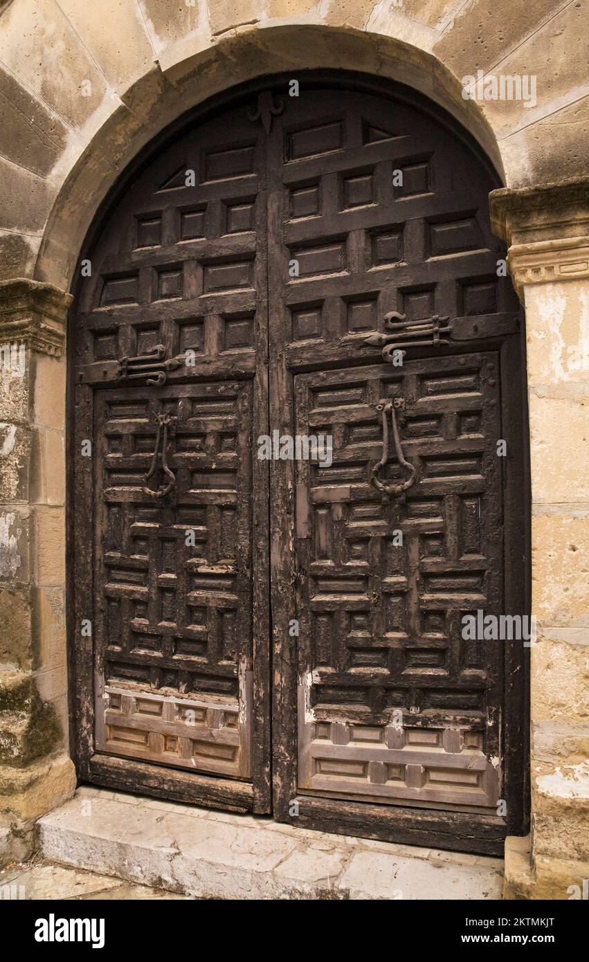Black wooden medieval doors on old architectural building, Seville, Spain. Stock Photo