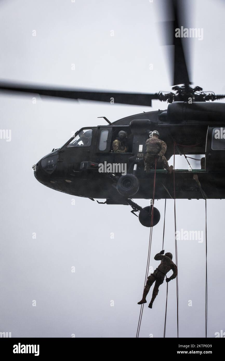 U.S. Army Soldiers repel out of a helicopter as part of the Air Assault certification course being conducted at Mihail Kogalniceanu Air Base, Romanian Nov. 29, 2022. Soldiers that undergo and complete the Air Assault certification are examples of the army's ambition to promote effectiveness, readiness and lethality. (U.S. Army photo by Pv2 Kyler Hembree) Stock Photo