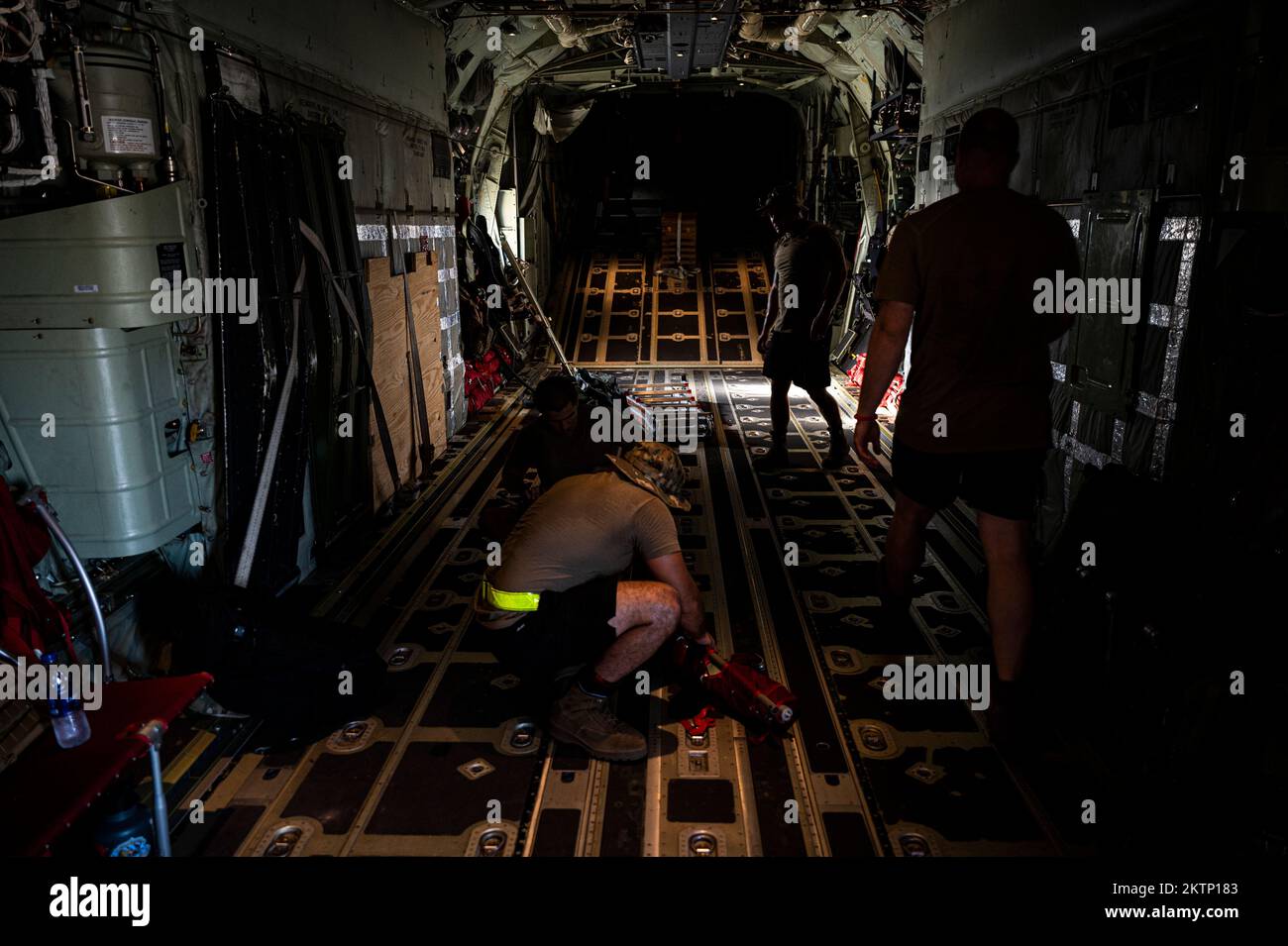 U.S. Air Force HC-130J Combat King II crew chiefs assigned to the 81st Expeditionary Rescue Squadron (ERQS) break down seats in a HC-130J, on Camp Lemonnier, Djibouti, Oct. 16, 2022. The 81st ERQS is a rapidly deployable combat search and rescue force that can conduct tactical air refueling, airdrop and airland of personnel and/or equipment during day or night operations in support of combat personnel recovery within Combined Joint Task Force – Horn of Africa area of responsibility. (U.S. Air Force photo by Staff Sgt. Devin M. Rumbaugh) Stock Photo