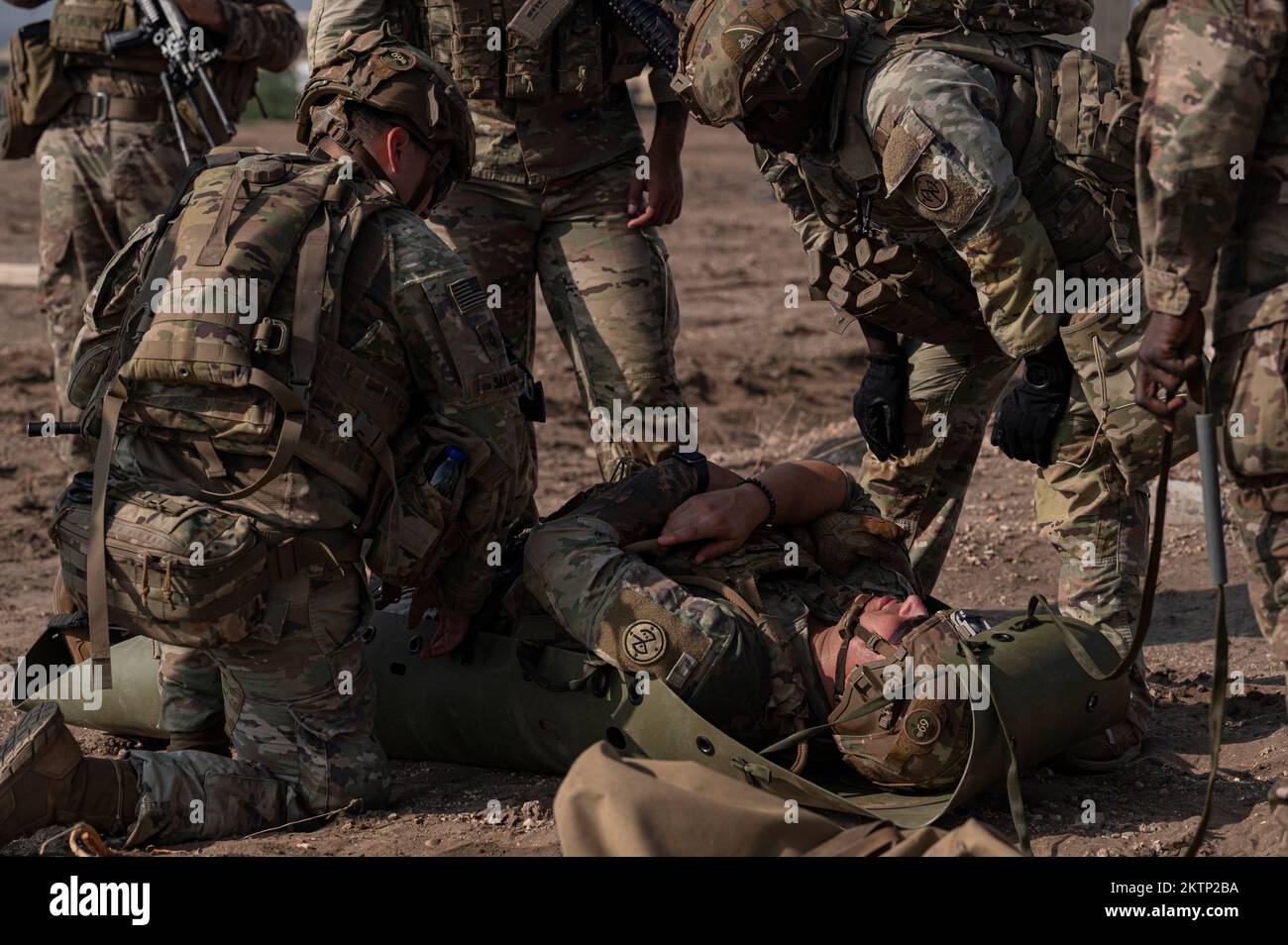 U.S. Army infantrymen assigned to the East Africa Response Force (EARF) position a simulated injured soldier on a litter at Camp Lemonnier, Djibouti, Nov. 17, 2022, during platoon and squad movement training. The EARF serves as part of U.S. Africa Command's crisis response capability, and is tasked with responding to emergency situations at U.S. Embassies in the East African region or in countries around the Combined Joint Task Force - Horn of Africa  area of interest. (U.S. Air Force photo by Senior Airman Bryan Guthrie) Stock Photo