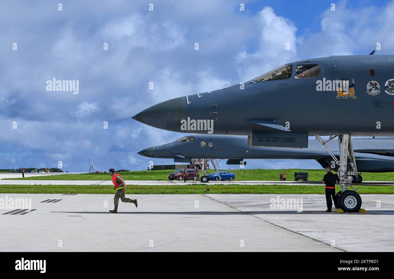 U.S. Air Force crew chief assigned to the  28th Aircraft Maintenance Squadron, Ellsworth Air Force Base, South Dakota, runs to marshal a B-1B Lancer in support of a Bomber Task Force mission at Andersen AFB, Guam, Nov. 14, 2022. Bomber missions demonstrate the credibility of U.S. armed forces to address a complex and uncertain security environment. (U.S. Air Force photo by Airman 1st Class Allison Martin) Stock Photo