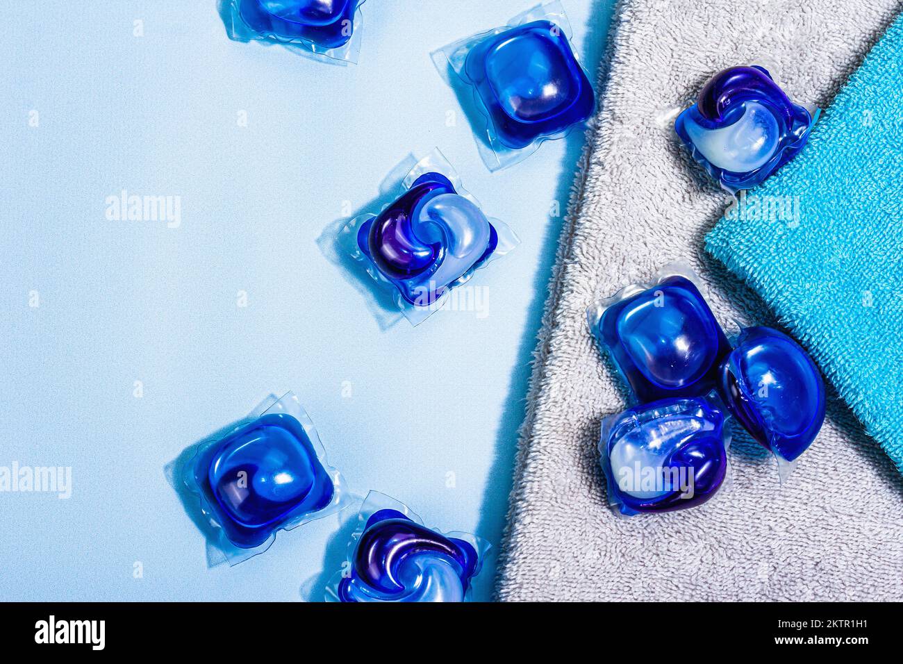 Machine washing concept. Capsules with detergent, soft towels, winter freshness. Laundry pods