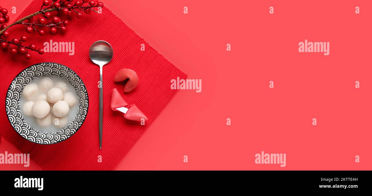 Bowl of tangyuan and fortune cookies on red background with space for ...