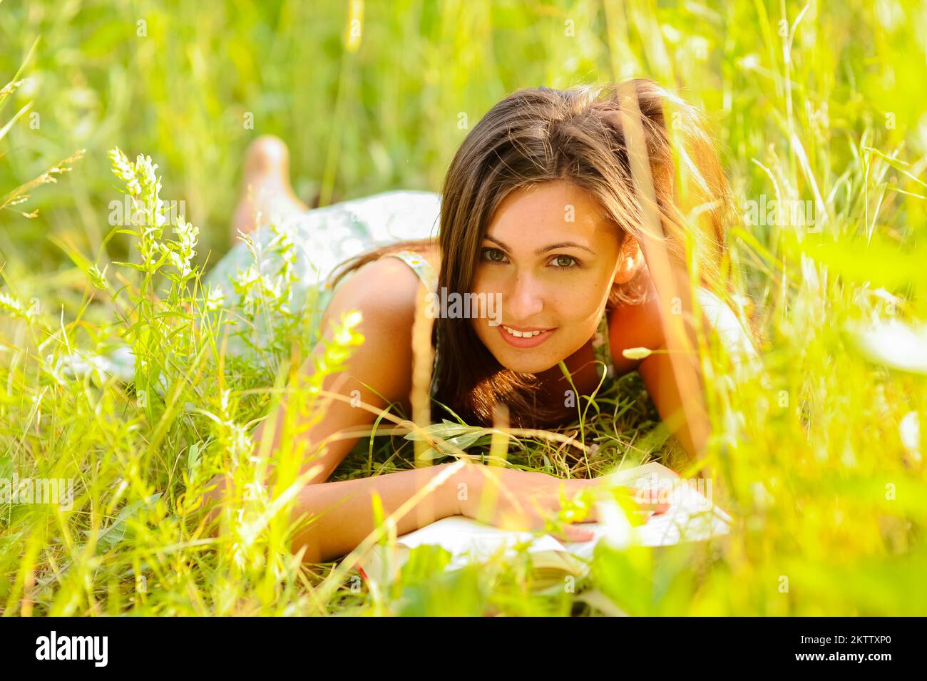 Young woman in green dress rest in the grass Stock Photo - Alamy
