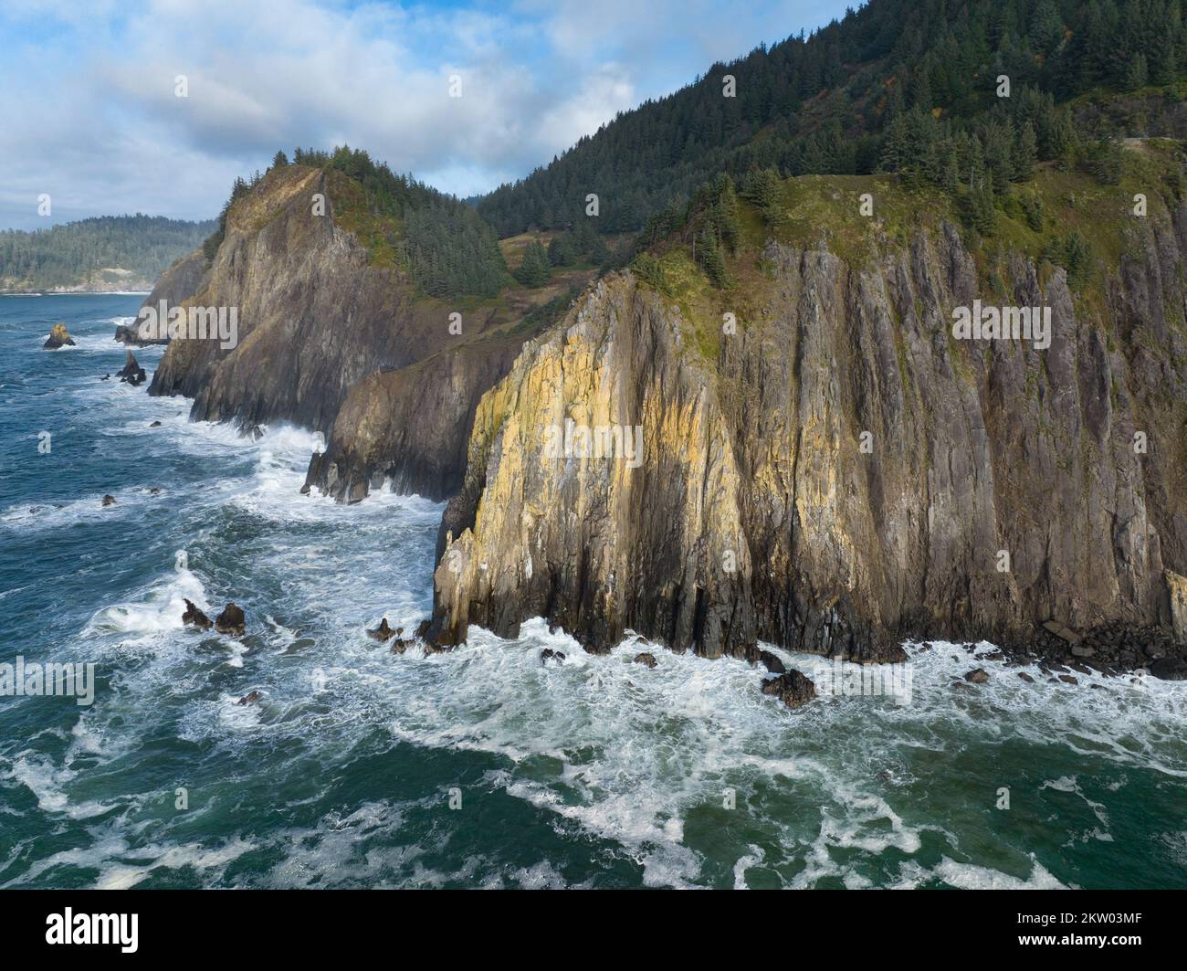 The cold Pacific Ocean washes against the rugged coastline of northern Oregon. This Pacific Northwest is known for its spectacular outdoor scenery. Stock Photo