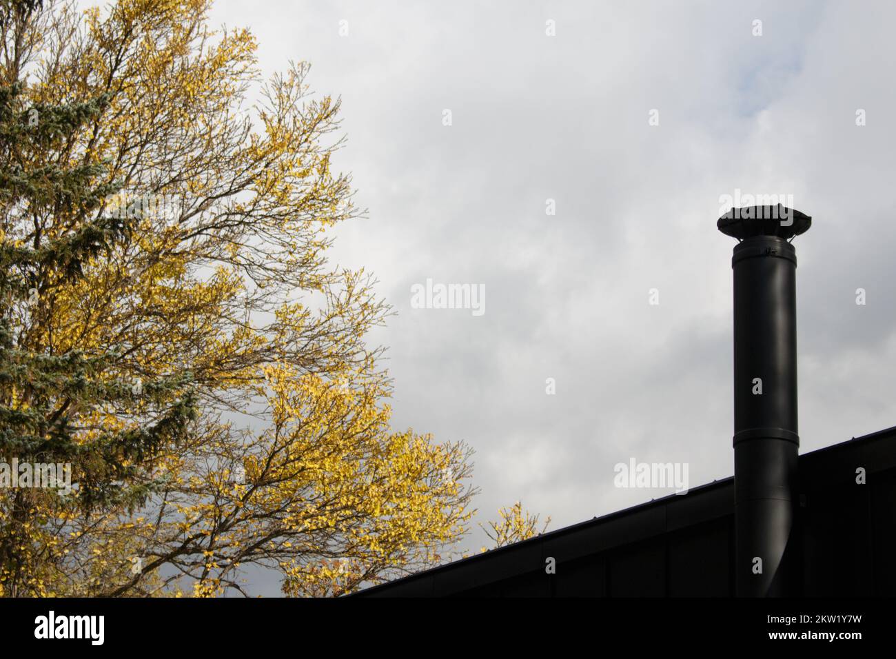Black metal chimney on log cabin roof Stock Photo Alamy