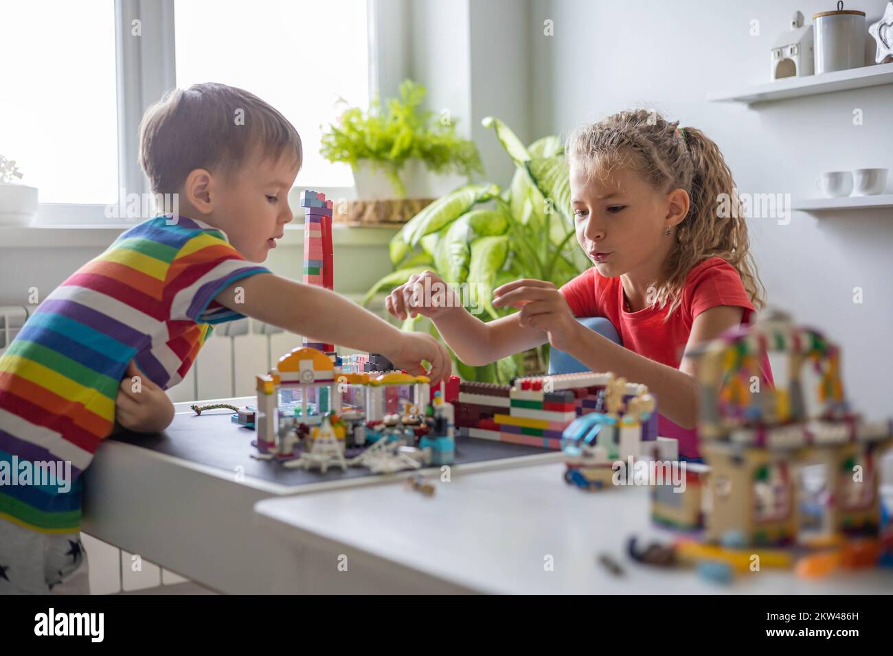 Children Using Lego Khabarovsk, Russia, August 25, 2022. Children constructing toy cars ...