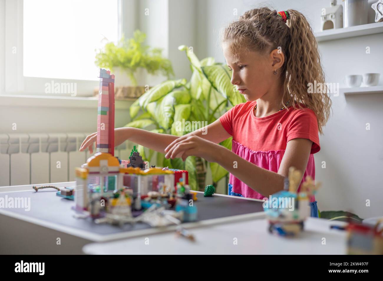 Children Using Lego Khabarovsk, Russia, August 25, 2022. Cute girl child constructing toy ...