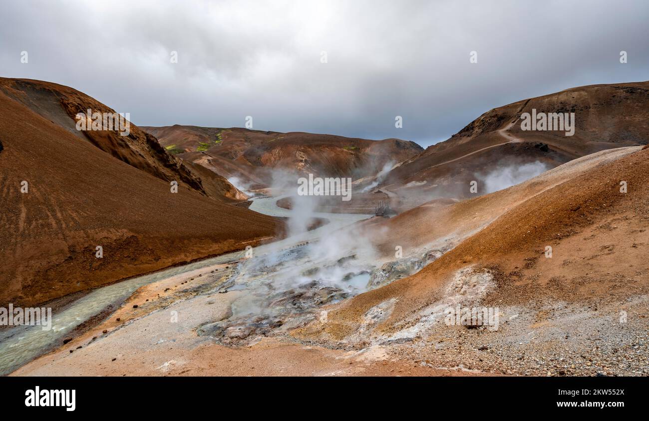 Hot springs and steaming stream between colourful rhyolite mountains